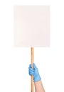 Protest sign in a hand in a blue medical glove