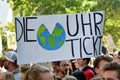 Protest sign saying `Time is ticking` in German held up by young people during Global Climate Strike