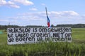 Protest signs and rows of flags upside down in Lekkerkerk along the N210 in the municipality of Krimpenerwaard