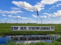 Protest signs and rows of flags upside down in Lekkerkerk along the N210 in the municipality of Krimpenerwaard