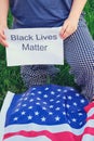 Protest in the United States, the American flag and the text Black Lives Matter. Concept of anti-racism protests and
