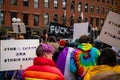 Protester marching for a peace pride rainbow flag at the Boston March for Our Lives political rally