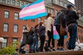 Protester marching for a peace pride rainbow flag at the Boston March for Our Lives political rally