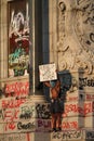 Protester stands on the Richmond Virginia Robert E.Lee statue holding up a sign