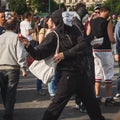 Protester throwing an egg during Mayday parade in Milan, Italy