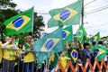 Protesters in green and yellow and with flags in front of the DCTA