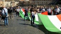 protesters hold up a huge tricolor marching from Piazza del Popolo to Piazza Venezia