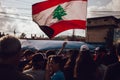 Protesters Rising Lebanese Flag in the Sky during Lebanon Civil Protests