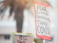 Protesters, sign and covid or demonstration with board, slogan and beliefs for fight against political views on medical