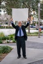 Protesting businessman holding a blank white posterboard over his head Royalty Free Stock Photo