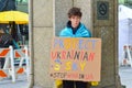 protestor holding a banner show solidarity for Ukraine