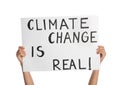 Protestor holding placard with text Climate Change Is Real on white background, closeup