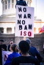 Female Protestor Holds Up Sign at anti-war Rally