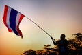 Protestor raises Thai flag at twilight