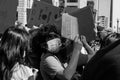 Protestor Wearing a Surgical Mask Looks Up at Helicopter Passing Over in Downtown Columbus Royalty Free Stock Photo