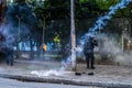 A protestor is throwing a molotov cocktail to a policeman