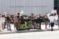 Protestors hold a banner outside LAPD headquarters