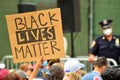 Protestors hold up signs