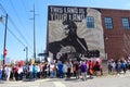 Protestors march by Woody Guthrie Mural that says This Machine Kills Fascists at March for Life protest in Tulsa Oklahoma 2 24 201 Royalty Free Stock Photo