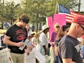 Protestors with signs and American flag