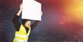 Protests yellow vests. Young man is holding a poster with lights on blue background