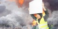 Protests yellow vests. A young man is holding a poster on street. Concept of revolution and protest, the struggle for equal rights