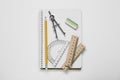 Protractor ruler, compass, pencil and notebook on white background, top view
