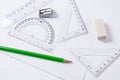 Protractor, rulers, pencil and eraser on squared paper Royalty Free Stock Photo