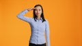 Proud adult presenting military salute symbol in studio Royalty Free Stock Photo