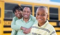 Proud African American Parents and Young Boy Near School Bus Royalty Free Stock Photo