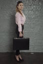 Proud business woman ready to work, briefcase in hand