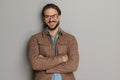 proud casual man with glasses crossing arms and laughing Royalty Free Stock Photo