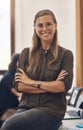 Proud, confident and ambitious portrait of smiling leader at desk looking professional. Elegant, fashionable and