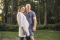 Posing proud, confident young couple, standing together in park, Royalty Free Stock Photo