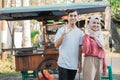 muslim small business entrepreneur with their food cart at the background