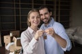 Proud couple of young new homeowners holding keys together Royalty Free Stock Photo