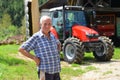 Proud farmer standing in front of his tractor Royalty Free Stock Photo