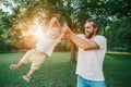 Proud father spinning toddler baby boy outdoors. Parent playing with child son in park. Authentic lifestyle funny moment. Happy Royalty Free Stock Photo