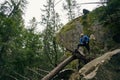 Proud foot traveller putting leg on fallen tree in forest Royalty Free Stock Photo