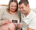 Proud future dad looking at an echography Royalty Free Stock Photo