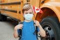 Proud happy boy student child with face mask holding Canadian flag. Education and back to school in September. New normal during Royalty Free Stock Photo