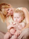 Proud of her little boy. Cute baby boy being held by his smiling mother while holding something. Royalty Free Stock Photo