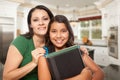 Proud Hispanic Mother and Daughter In Kitchen at Home Ready for Royalty Free Stock Photo