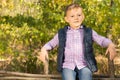 Proud little boy sitting on a wooden fence Royalty Free Stock Photo