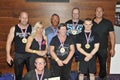 Proud male and female contestants showing their medals and trophy