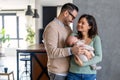 Proud mother and father smiling at their newborn baby daughter, son at home Royalty Free Stock Photo