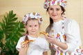 Portrait of a five-year-old daughter with her mother and a slice of pizza in her hand. After working together in the Royalty Free Stock Photo