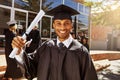 Proud of my scholastic success. Portrait of a smiling university student holding his diploma outside on graduation day. Royalty Free Stock Photo