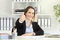 Proud office worker posing with thumbs up