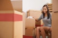 Proud owner of a new home. Portrait of a beautiful young woman surrounded by boxes in her new home. Royalty Free Stock Photo